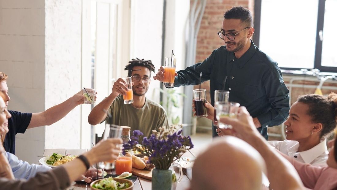 vegan community - friends eating around a table