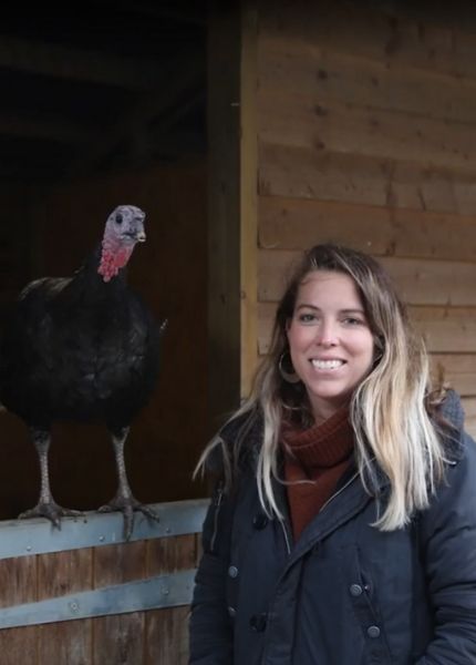 woman stands with rescue turkey