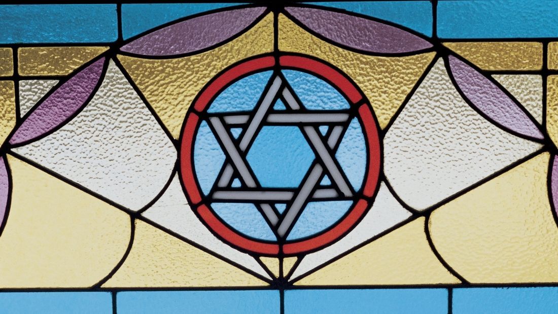 stain glass window with the star of david on it