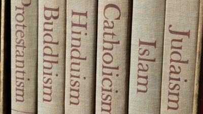 row of books with different religions written on them