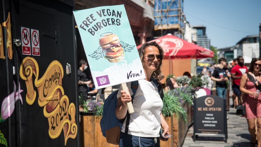 Volunteer holding burger sign