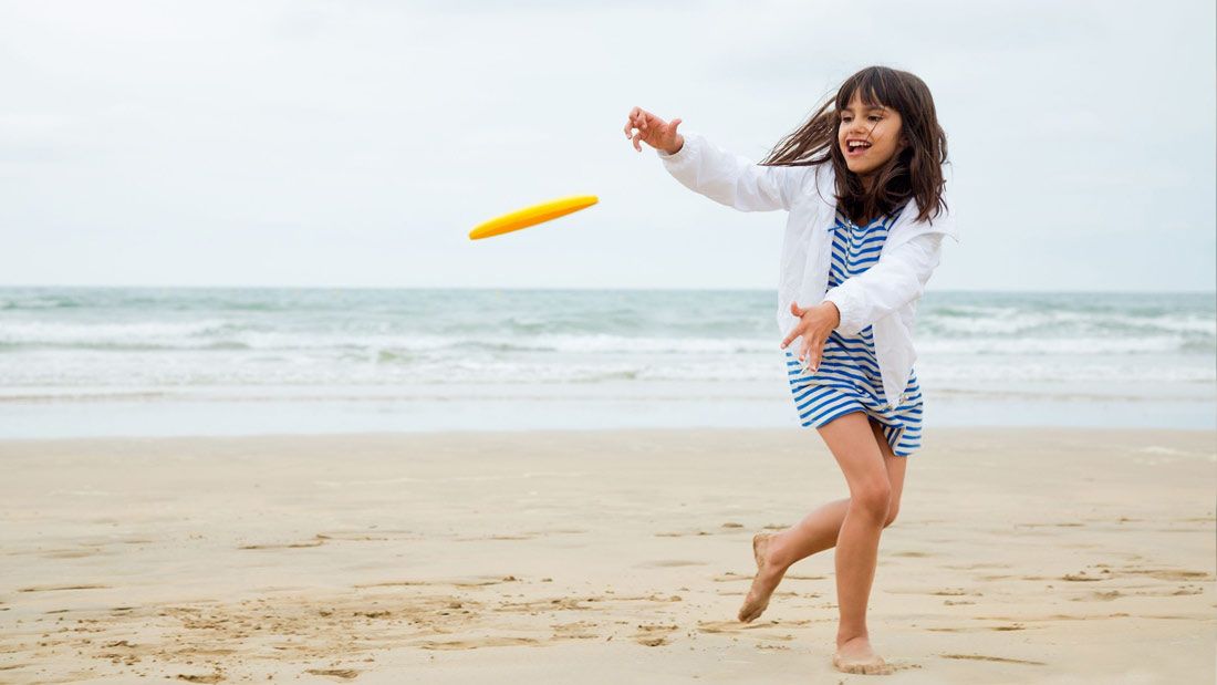 girl playing frisbee